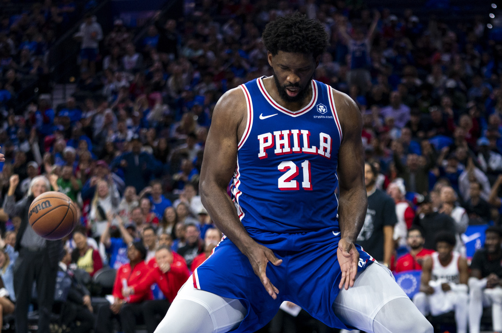 Philadelphia 76ers' Joel Embiid reacts after his basket and a foul called against Portland Trail Blazers' Malcolm Brogdon during the first half of an NBA basketball game, 