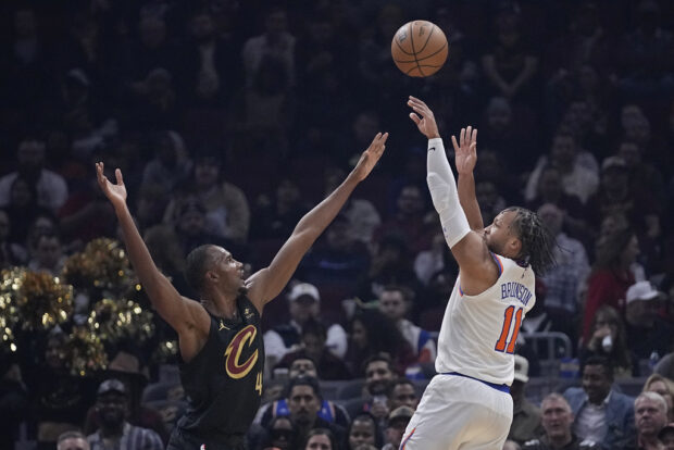 New York Knicks guard Jalen Brunson (11) shoots over Cleveland Cavaliers forward Evan Mobley (4) during the first half of an NBA basketball game Tuesday, Oct. 31, 2023, in Cleveland