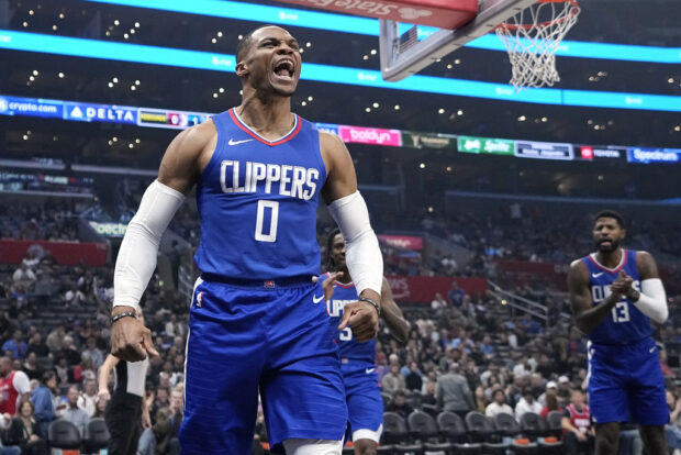 Los Angeles Clippers guard Russell Westbrook, left, celebrates after blocking a shot during the first half of an NBA basketball game against the Orlando Magic Tuesday, Oct. 31, 2023, in Los Angeles.