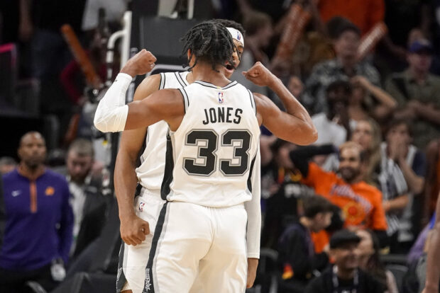 San Antonio Spurs' Tre Jones (33) celebrates with Keldon Johnson after Johnson's basket against the Phoneix Suns with just over a second left in an NBA basketball game in Phoenix, Tuesday, Oct. 31, 2023.