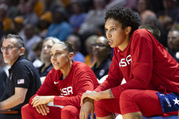 Team USA center Brittany Griner, right, and guard Diana Taurasi, center, watch play during the second half of an NCAA college basketball exhibition game against Tennessee, Sunday, Nov. 5, 2023, in Knoxville, Tenn