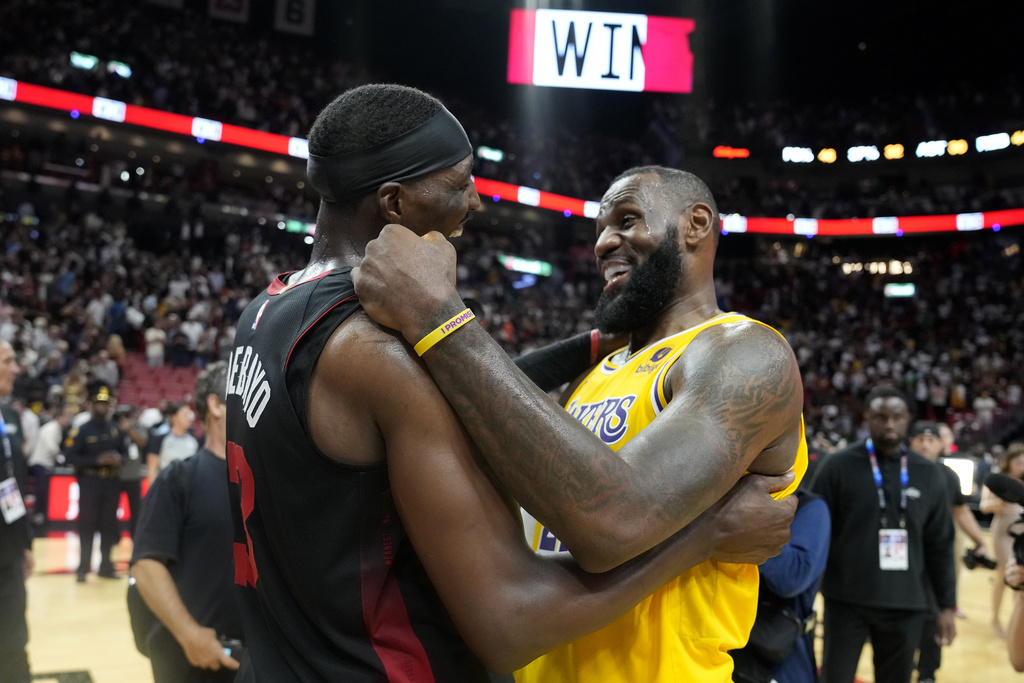 Miami Heat center Bam Adebayo, left, and Los Angeles Lakers forward LeBron James, right, meet on the court after an NBA basketball game, Monday, Nov. 6, 2023, in Miami. 