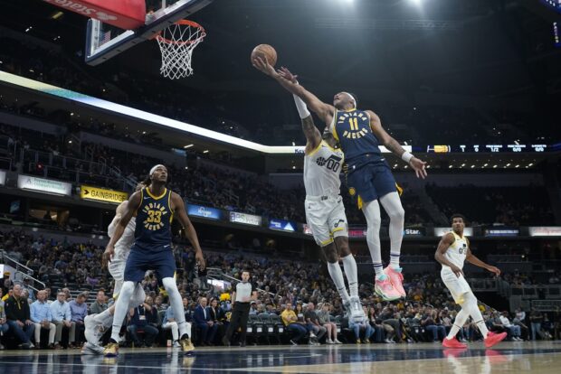 Indiana Pacers' Bruce Brown (11) puts up a shot against Utah Jazz's Jordan Clarkson (00) during the first half of an NBA basketball game, Wednesday, Nov. 8, 2023, in Indianapolis