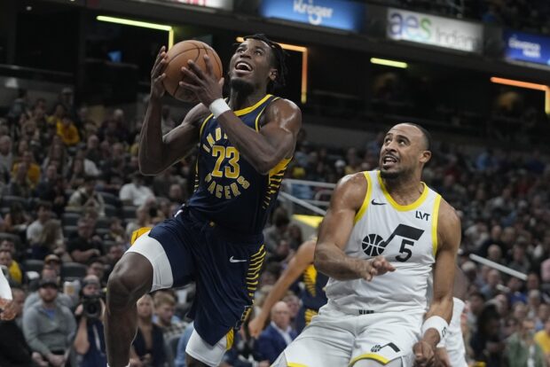 Indiana Pacers' Aaron Nesmith (23) puts up a shot against Utah Jazz's Talen Horton-Tucker (5) during the first half of an NBA basketball game, Wednesday, Nov. 8, 2023, in Indianapolis.