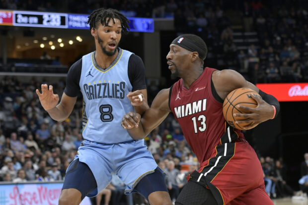 Miami Heat center Bam Adebayo (13) handles the ball against Memphis Grizzlies forward Ziaire Williams (8) in the first half of an NBA basketball game, Wednesday, Nov. 8, 2023, in Memphis, Tenn.