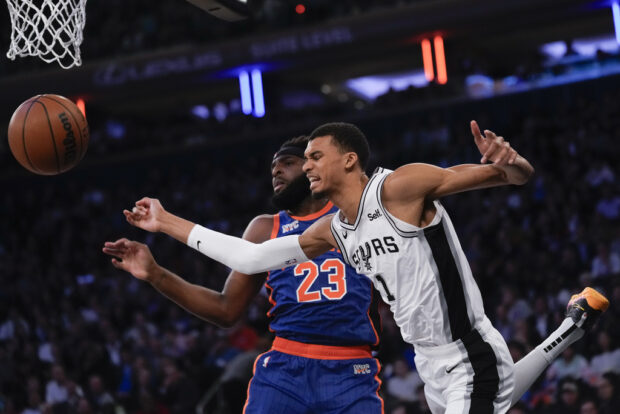 San Antonio Spurs' Victor Wembanyama, right, and New York Knicks' Mitchell Robinson fight for a rebound during the first half of an NBA basketball game, Wednesday, Nov. 8, 2023, in New York.