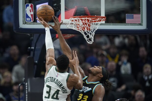 Indiana Pacers' Myles Turner (33) blocks the shot of Milwaukee Bucks' Giannis Antetokounmpo (34) during the first half of an NBA basketball game, Thursday, Nov. 9, 2023, in Indianapolis