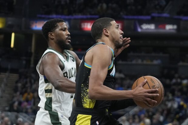 Indiana Pacers' Tyrese Haliburton, right, goes to the basket against Milwaukee Bucks' Malik Beasley during the first half of an NBA basketball game, Thursday, Nov. 9, 2023, in Indianapolis.