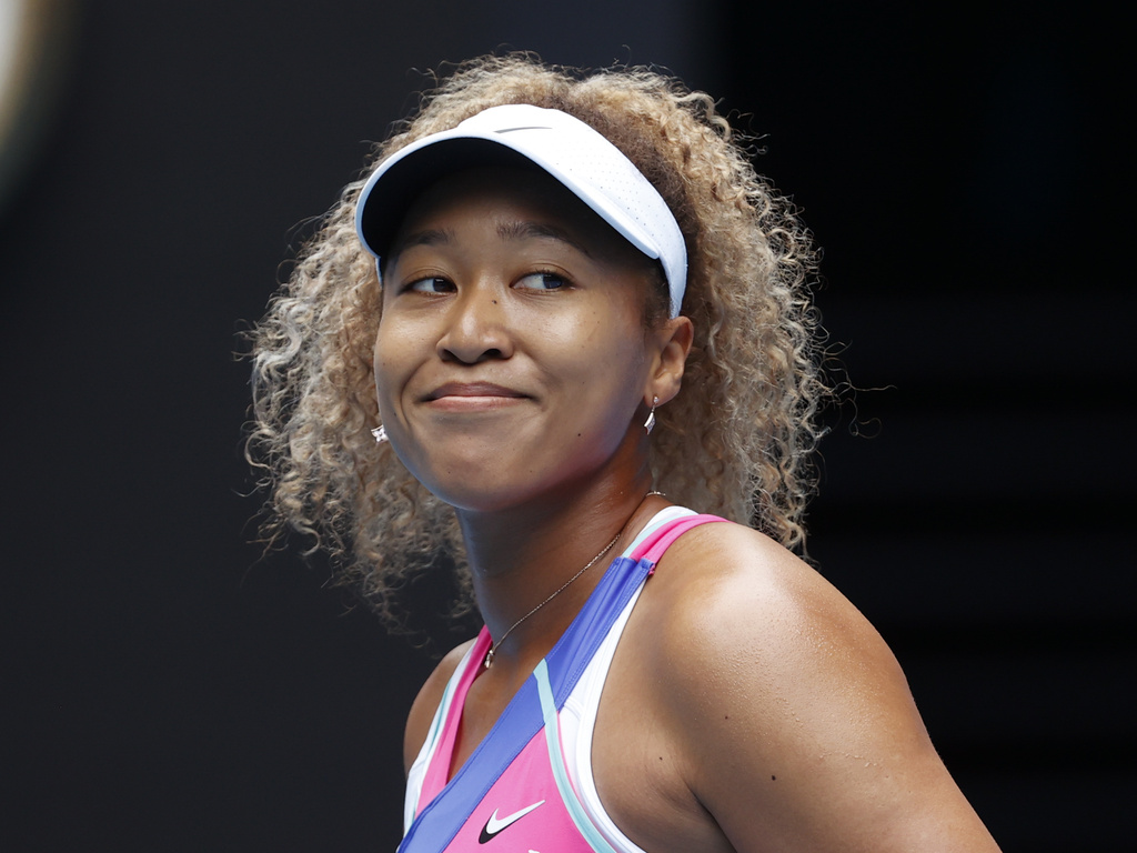 FILE - Naomi Osaka of Japan smiles during her first round match against Camila Osorio of Colombia at the Australian Open tennis championships, Jan. 17, 2022, in Melbourne, Australia.