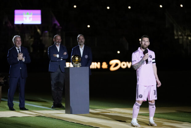 Inter Miami forward Lionel Messi, right, speaks during a ceremony honoring his Ballon d'Or trophy, before the team's club friendly soccer match against New York City FC, Friday, Nov. 10, 2023, in Fort Lauderdale, Florida.