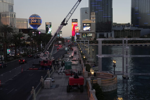 Construction workers build a grandstand in front of the fountains at Bellagio hotel-casino along the Las Vegas Strip ahead of the Las Vegas Formula One Grand Prix auto race Tuesday, Sept. 19, 2023, in Las Vegas