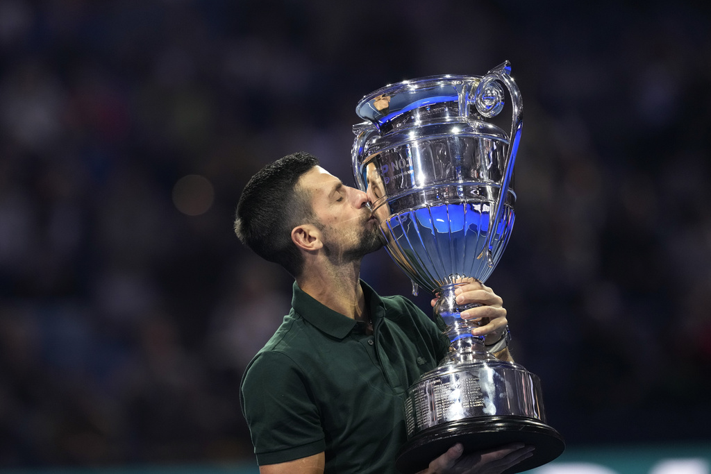 Serbia's Novak Djokovic kisses the trophy as ATP world best player at the ATP World Tour Finals, at the Pala Alpitour, in Turin, Italy, Monday, Nov. 13, 2023. Djokovic was presented with the trophy for finishing the year ranked No. 1. 