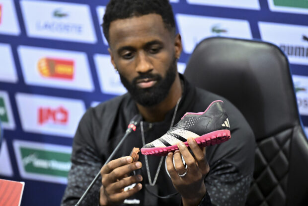 Israel team captain Eli Dasa shows a shoe of a kidnapped Israeli boy during a press conference, before a training session for the Euro 2024 group I qualifying soccer match between Israel and Switzerland at the Pancho Arena in Felcsút, Hungary, Tuesday, Nov. 14, 2023. 