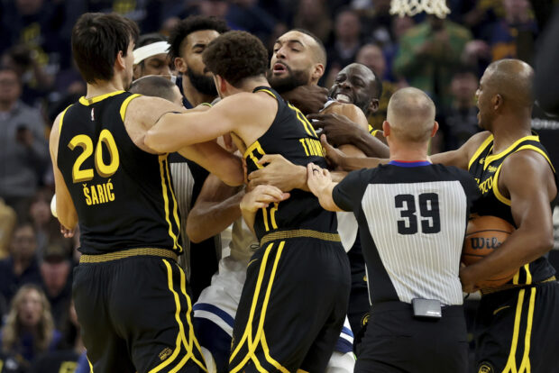 Golden State Warriors guard Klay Thompson, front, Draymond Green, left, gets into an altercation with Minnesota Timberwolves center Rudy Gobert, back, during the first half of an in-season NBA tournament basketball game in San Francisco, Tuesday, Nov. 14, 2023. They were both ejected from the game.