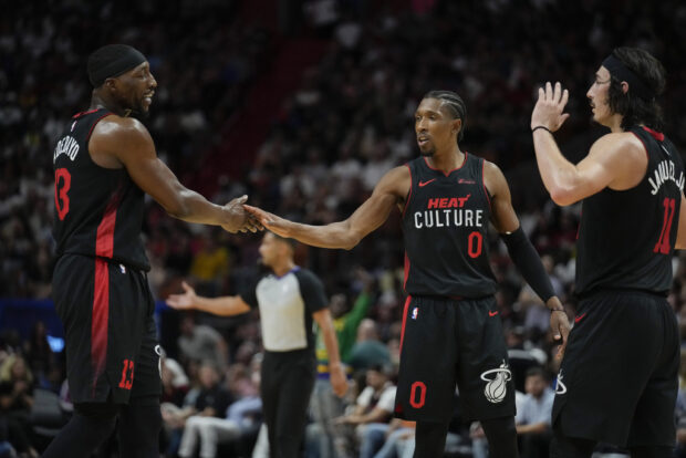 Miami Heat center Bam Adebayo (13) celebrates with guards Josh Richardson (0) and Jaime Jaquez Jr. (11) during the second half of an NBA basketball game against the Brooklyn Nets, Thursday, Nov. 16, 2023, in Miami.