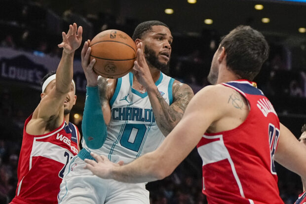 Charlotte Hornets forward Miles Bridges drives to the basket between Washington Wizards center Daniel Gafford and forward Danilo Gallinari during the second half of an NBA basketball game on Wednesday, Nov. 22, 2023, in Charlotte, N.C. 