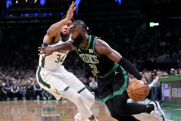 Boston Celtics guard Jaylen Brown (7) drives to the basket past Milwaukee Bucks forward Giannis Antetokounmpo (34) during the first half of an NBA basketball game Wednesday, Nov. 22, 2023, in Boston.