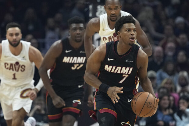 Miami Heat's Kyle Lowry (7) brings the ball up in front of Cleveland Cavaliers guard Max Strus, left, Heat center Thomas Bryant (31) and Cavaliers forward Evan Mobley during the first half of an NBA basketball game, Wednesday, Nov. 22, 2023, in Cleveland. 