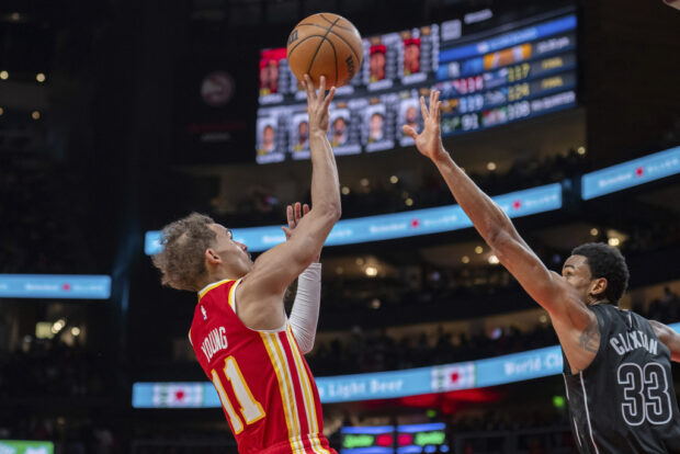 Atlanta Hawks guard Trae Young (11) shoots over Brooklyn Nets center Nic Claxton (33) during the second half of an NBA basketball game Wednesday, Nov. 22, 2023, in Atlanta. 