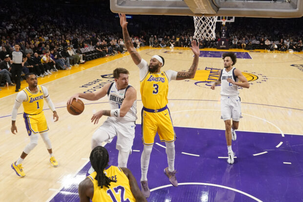 econd from left, makes a behind-the-back pass to center Dereck Lively II (2, past Los Angeles Lakers forward Anthony Davis (3) during the first half of an NBA basketball game Wednesday, Nov. 22, 2023, in Los Angeles. 