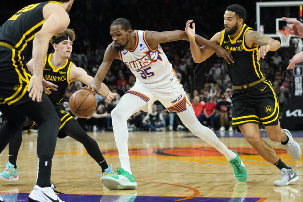 Phoenix Suns forward Kevin Durant (35) drives against the Golden State Warriors during the second half of an NBA basketball game, Wednesday, Nov. 22, 2023, in Phoenix.