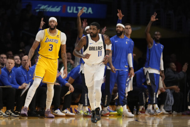 Dallas Mavericks guard Kyrie Irving (11) runs back after making a three-point basket against the Los Angeles Lakers during the first half of an NBA basketball game Wednesday, Nov. 22, 2023, in Los Angeles. 