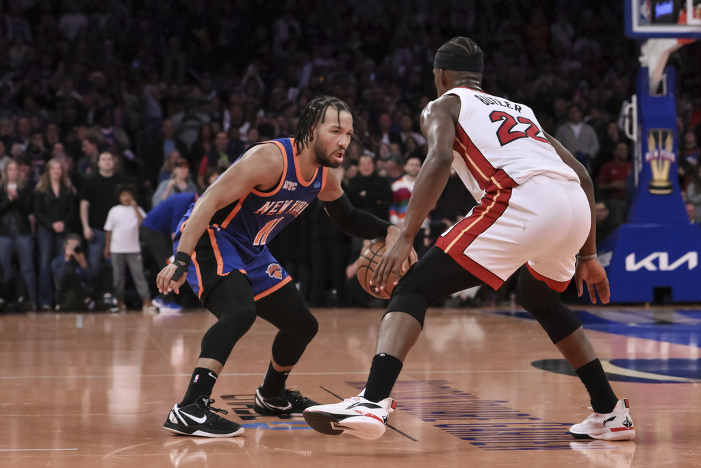 New York Knicks guard Jalen Brunson (11) looks to get past Miami Heat forward Jimmy Butler (22) during the second half of an NBA basketball In-Season Tournament game, Friday, Nov. 24, 2023, in New York