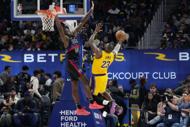 Los Angeles Lakers forward LeBron James (23) shoots over the defense of Detroit Pistons center Isaiah Stewart (28) during the first half of an NBA basketball game, Wednesday, Nov. 29, 2023, in Detroit.