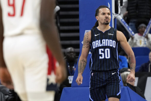 Orlando Magic guard Cole Anthony (50) reacts after sinking a dunk on an ally oop pass from teammate guard Jalen Suggs during the second half of an NBA basketball game against the Washington Wizards, Wednesday, Nov. 29, 2023, in Orlando, Florida.