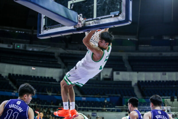 La Salle star Kevin Quiambao hangs from the rim during a UAAP game
