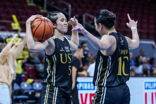 UST Tigresses' Kent Pastrana and Reynalymn Ferrer in Game 1 of the UAAP women's basketball Finals.