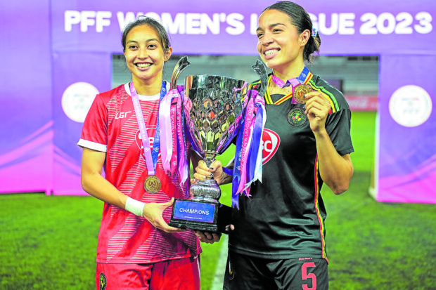 Hali Long (right) and Inna Palacios pose with the trophy. —PHILIPPINE FOOTBALL FEDERATION