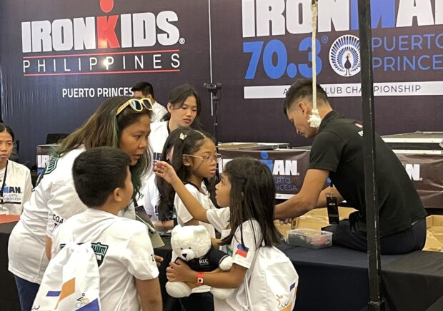 IronKids participants get their racing kits at registration booth.