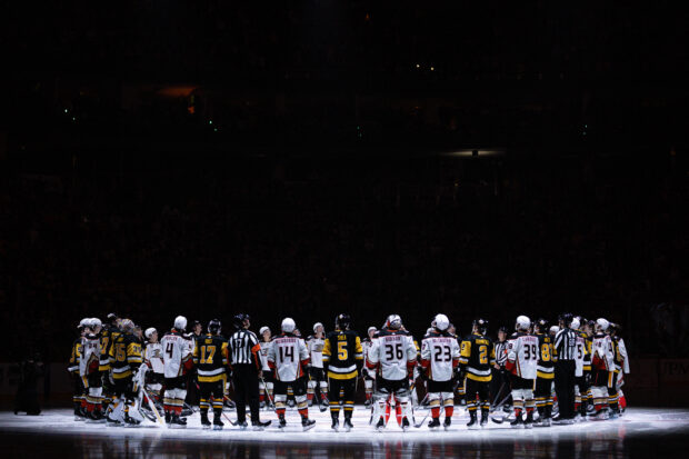  Pittsburgh Penguins and Anaheim Ducks players stand for a moment of silence following the death of former Penguins player Adam Johnson, prior to their game at PPG PAINTS Arena on October 30, 2023 in Pittsburgh, Pennsylvania. 
