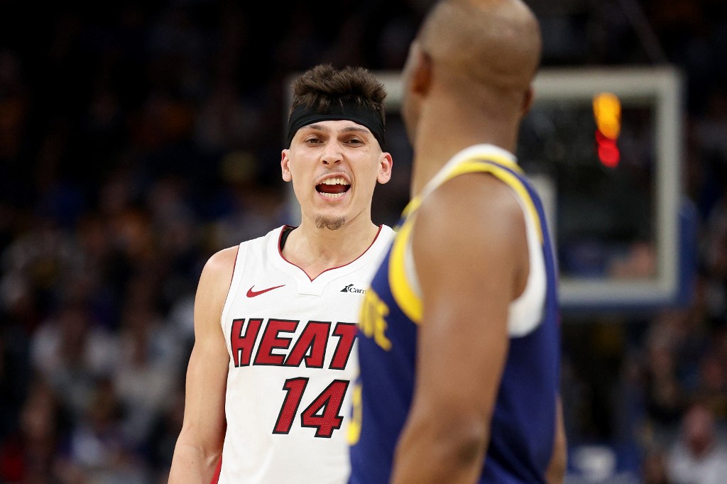  Tyler Herro #14 of the Miami Heat has words with Chris Paul #3 of the Golden State Warriors in the second half at Chase Center on December 28, 2023 in San Francisco, California