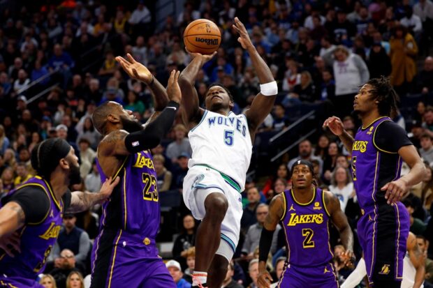  Anthony Edwards #5 of the Minnesota Timberwolves goes up for a shot while LeBron James #23 of the Los Angeles Lakers defends in the first quarter at Target Center on December 30, 2023 in Minneapolis, Minnesota. 