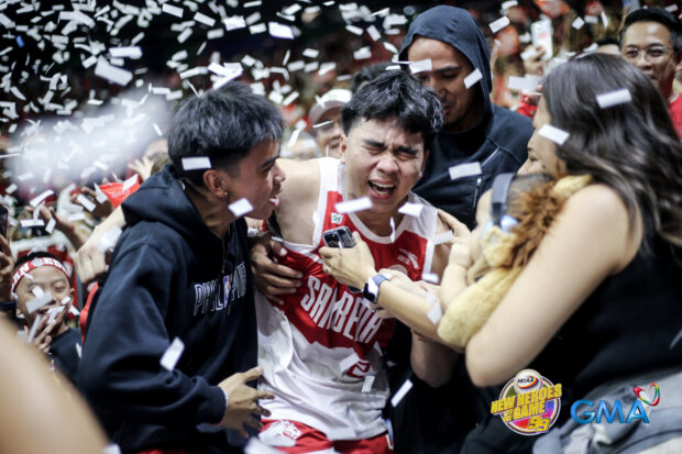 Jacob Cortez hugs his family including father Mike Cortez as San Beda wins NCAA title