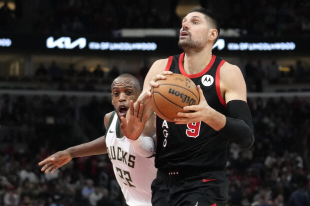 Chicago Bulls' Nikola Vucevic eyes the basket as Milwaukee Bucks' Khris Middleton defends during the first half of an NBA basketball game, Thursday, Nov. 30, 2023, in Chicago.