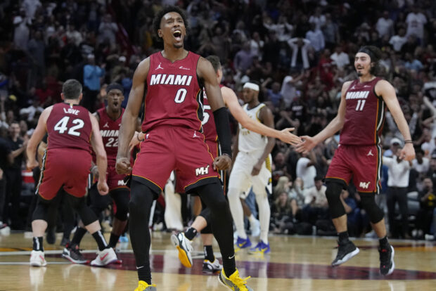 Miami Heat guard Josh Richardson (0) celebrates with teammates after forward Jaime Jaquez Jr. (11) scored during the second half of an NBA basketball game against the Indiana Pacers, Thursday, Nov. 30, 2023, in Miami. 
