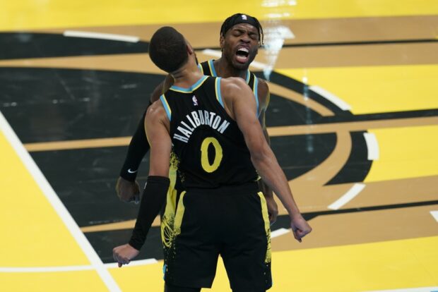 Indiana Pacers' Tyrese Haliburton (0) and Buddy Hield, right, celebrate during the second half of an NBA basketball In-Season Tournament game against the Boston Celtics, Monday, Dec. 4, 2023, in Indianapolis