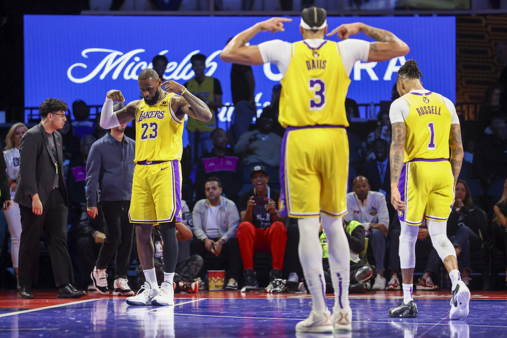 Los Angeles Lakers forward LeBron James (23), forward Anthony Davis (3) and guard D'Angelo Russell (1) react after James' 3-point basket against the New Orleans Pelicans during the second half of a semifinal in the NBA basketball In-Season Tournament, Thursday, Dec. 7, 2023, in Las Vegas.