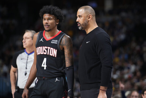 Houston Rockets coach Ime Udoka, right, confers with guard Jalen Green during a break in play in the first half of the team's NBA basketball game against the Denver Nuggets on Friday, Dec. 8, 2023, in Denver.