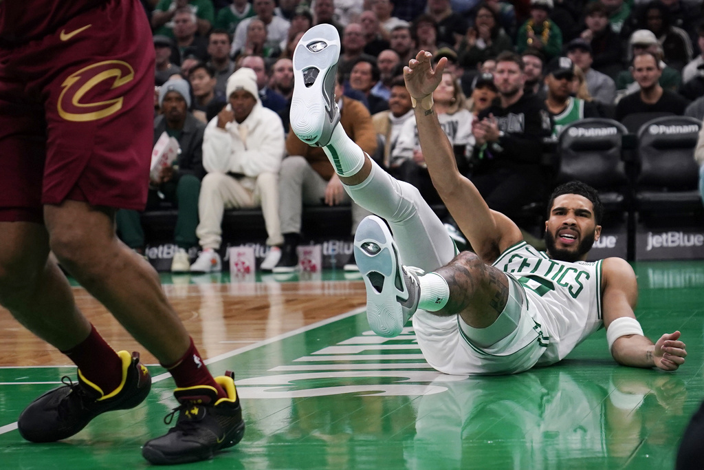 Boston Celtics forward Jayson Tatum hits the ground after missing a shot on a drive to the basket against the Cleveland Cavaliers during the first half of an NBA basketball game, Tuesday, Dec. 12, 2023, in Boston.