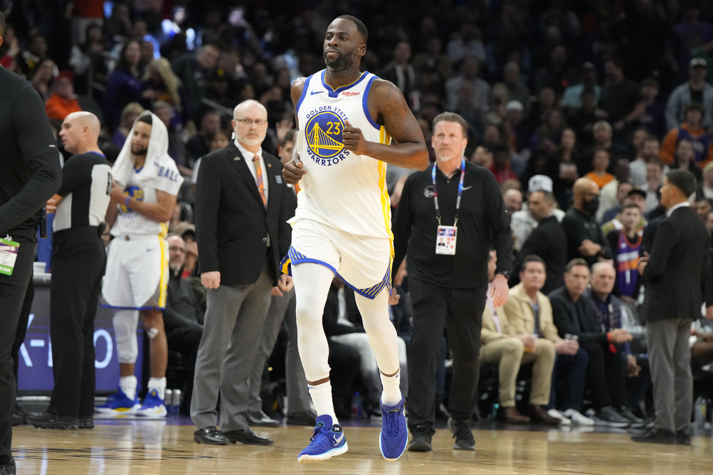 Golden State Warriors forward Draymond Green (23) jogs off the court after getting ejected during the second half of an NBA basketball game against the Phoenix Suns, Tuesday, Dec. 12, 2023, in Phoenix.