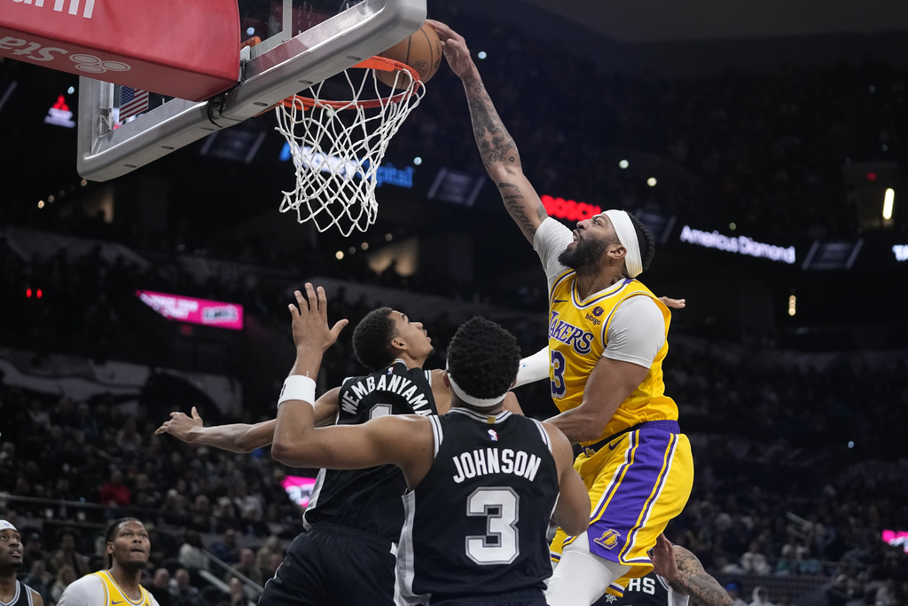 Los Angeles Lakers forward Anthony Davis (3) scores over San Antonio Spurs center Victor Wembanyama (1) during the first half of an NBA basketball game in San Antonio, Wednesday, Dec. 13, 2023.