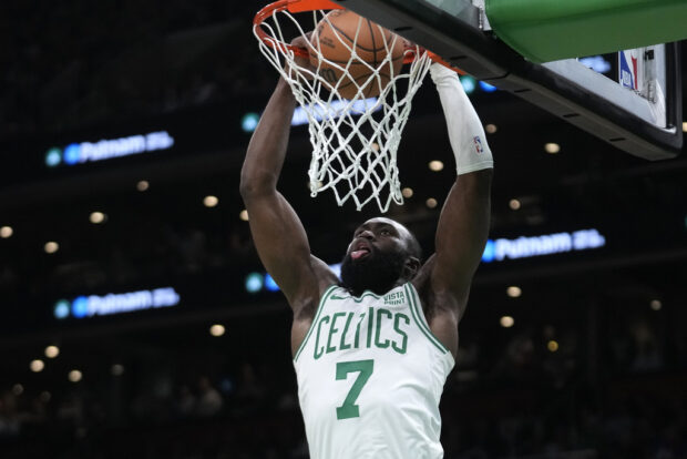 Boston Celtics guard Jaylen Brown scores in the first half of an NBA basketball game against the Cleveland Cavaliers, Thursday, Dec. 14, 2023, in Boston.