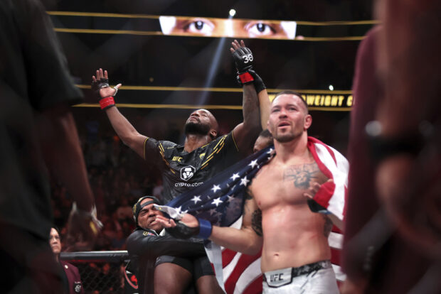 UFC welterweight champion Leon Edwards, left, celebrates after being declared the winner by unanimous decision over Colby Covington, right, during the UFC 296 mixed martial arts event Saturday, Dec. 16, 2023, in Las Vegas. 