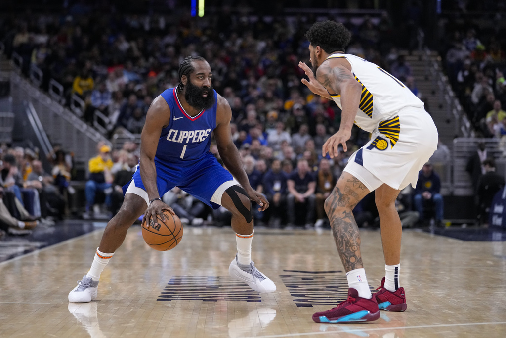 Los Angeles Clippers guard James Harden (1) drives on Indiana Pacers forward Obi Toppin (1) during the second half of an NBA basketball game in Indianapolis, Monday, Dec. 18, 2023. 