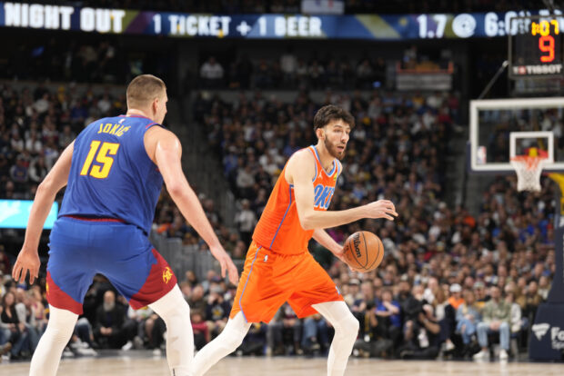 Denver Nuggets center Nikola Jokic (15) covers Oklahoma City Thunder forward Chet Holmgren (7) in the second half of an NBA basketball game Saturday, Dec. 16, 2023, in Denver.