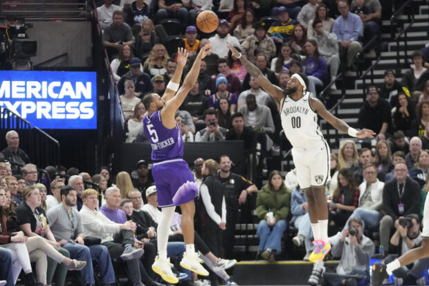 Utah Jazz guard Talen Horton-Tucker (5) shoots as Brooklyn Nets forward Royce O'Neale (00) defends during the second half of an NBA basketball game Monday, Dec. 18, 2023, in Salt Lake City. 
